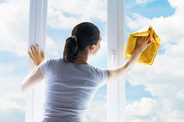 窓をピカピカに拭く女性